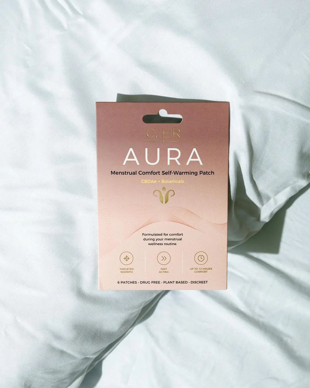 The AURA Self-Warming Patch pack, made with CBDAe and botanicals